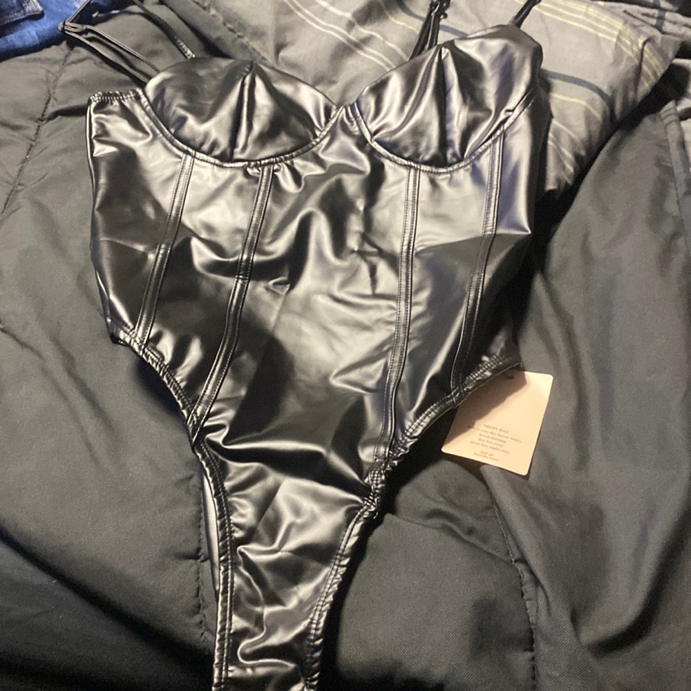 Large black leather bodysuit
